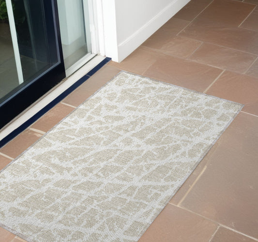 2' X 3' Beige and Ivory Abstract Washable Non Skid Indoor Outdoor Area Rug