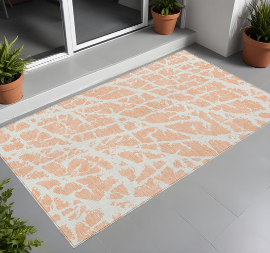 2' X 3' Peach and Ivory Abstract Washable Non Skid Indoor Outdoor Area Rug